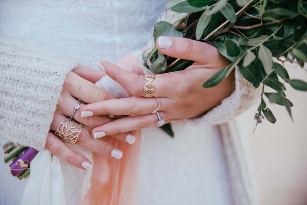 Wedding, bride, and groom walking at the beach . Wedding photographer london