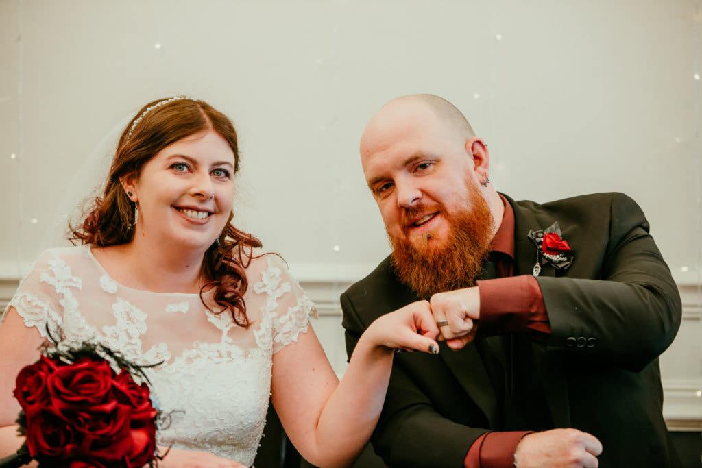 Wedding ceremony , white dress, black suit, red shirt, ring ceremony