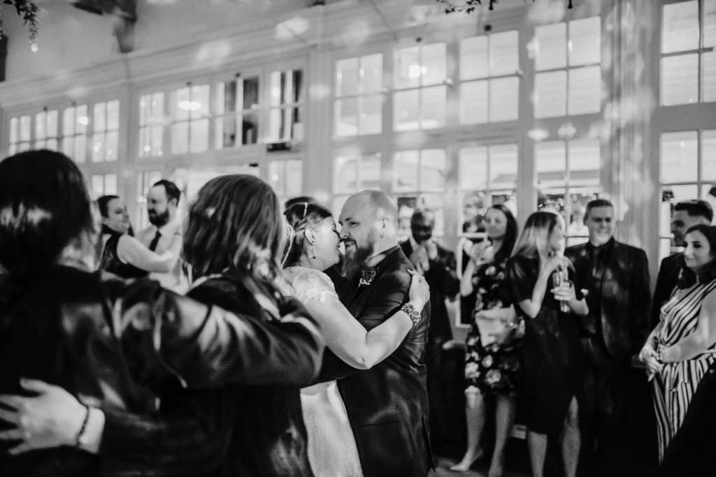 Dancing couple at the wedding reception Shenley cricket club , white wedding dress, black and red themed wedding