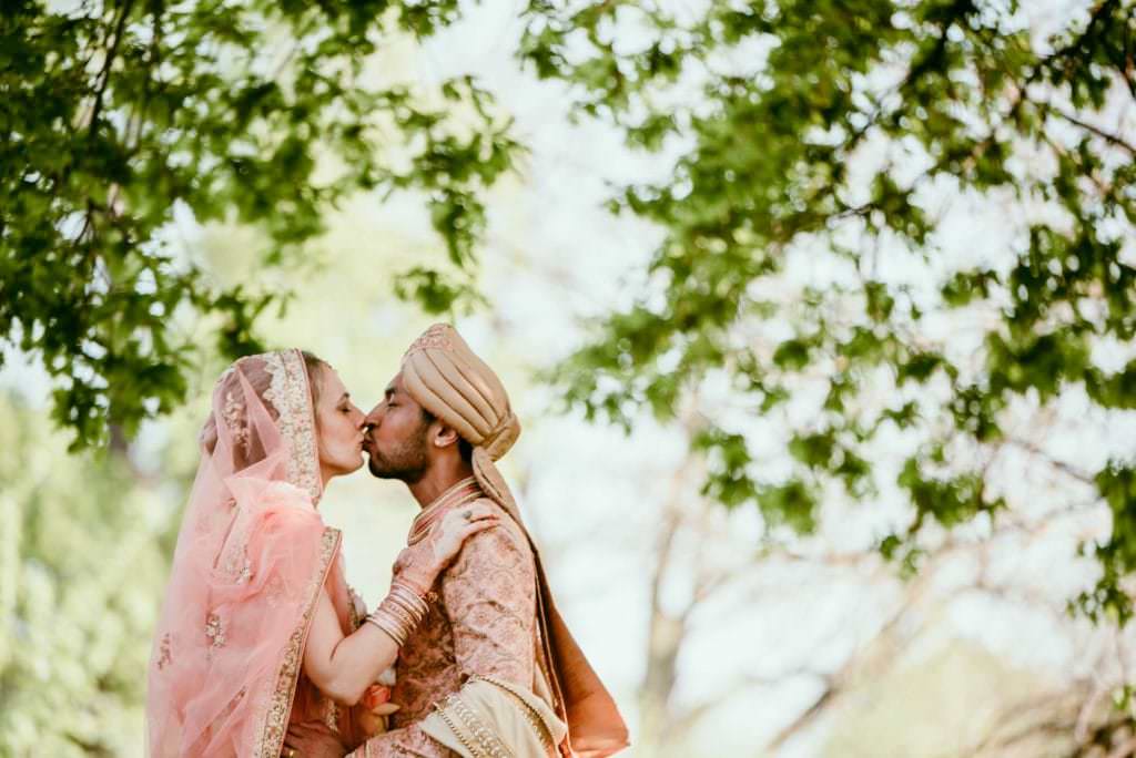 bride and groom looking at each other kissing