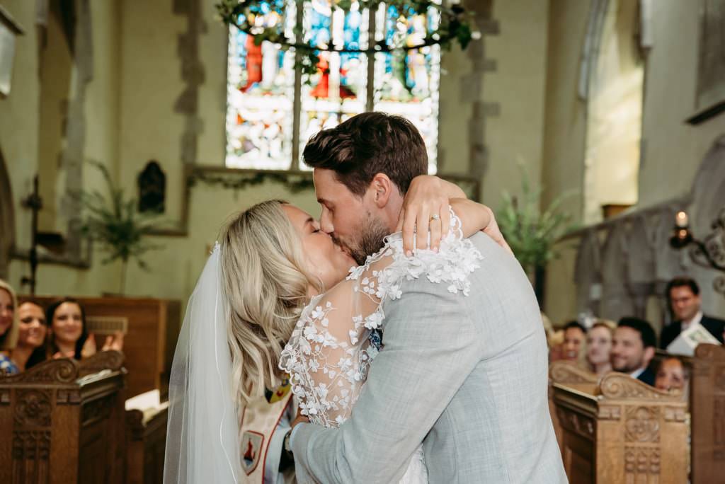 festival-theme-surrey-wedding-roshni-photography-church-ceremony-first-kiss